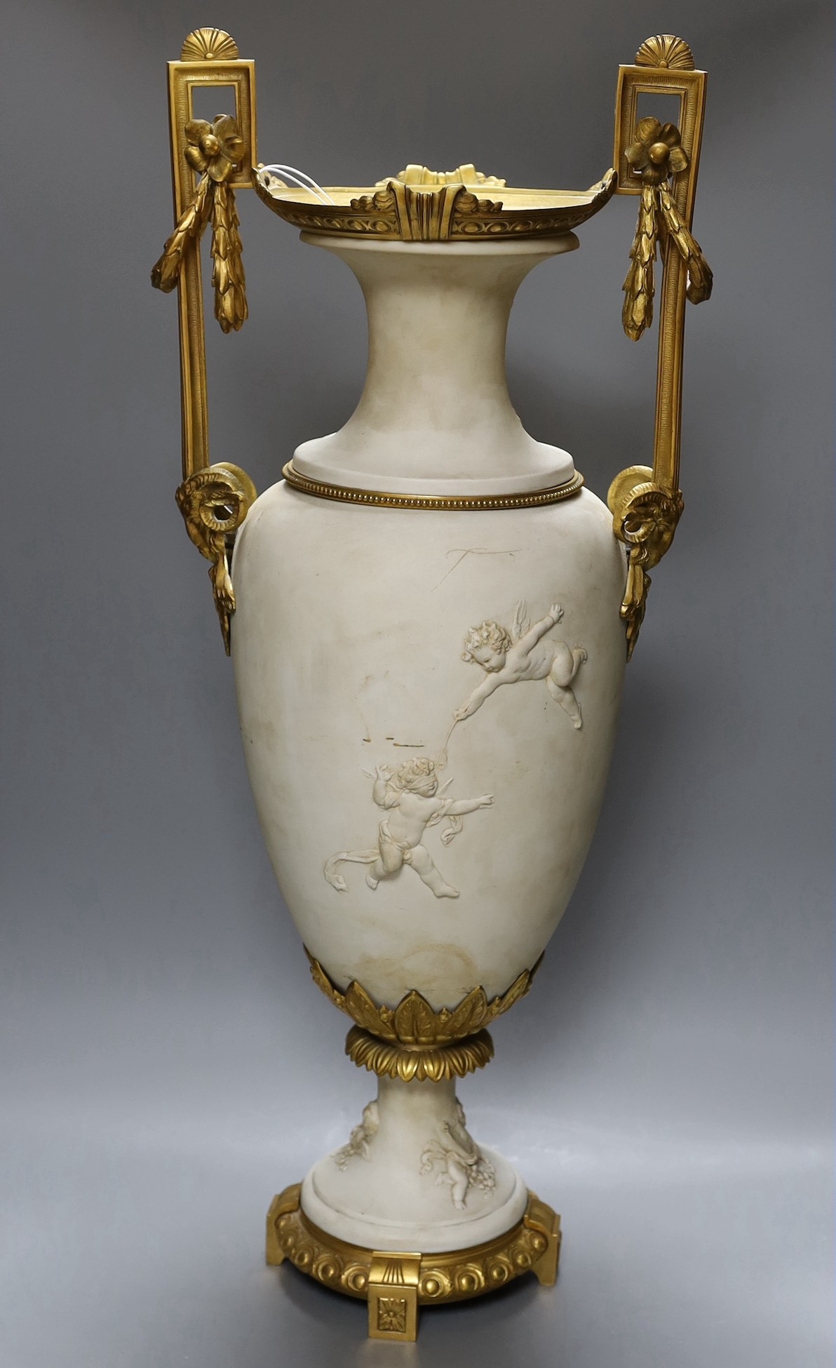 A large Louis XVI style ormolu mounted biscuit porcelain urn - 63cm tall